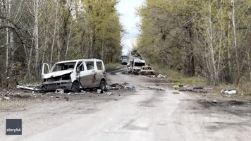 Burned Out Vehicles Scattered Along Road Near Lyman