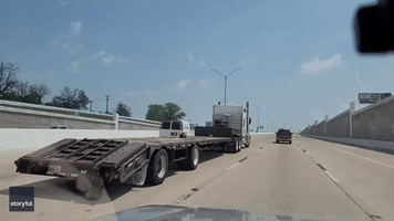 Flatbed Transports Tiny Toy Truck on Interstate 35