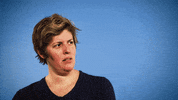 Celebrity gif. Sally Kohn turns her head to look at us with suspicion, squinting.