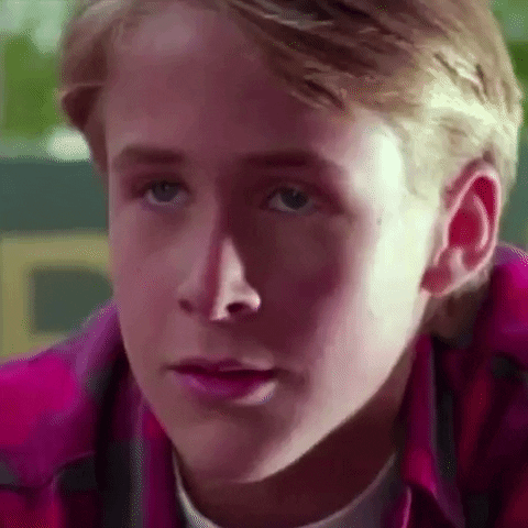 TV gif. Ryan Gosling as Jamie in Are You Afraid of the Dark? He's smirking and gives us a slight nod of his head, challenging us.