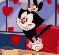 Cartoon gif. Dot Warner from Animaniacs has her ears tied together with a flower hair tie as she stands bashfully in a pink skirt. She smiles shyly while a bunch of beating red hearts surround her.