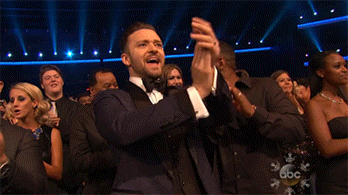 Celebrity gif. Justin Timberlake at the AMAs claps and yells enthusiastically in the crowd while donning a classy tuxedo.