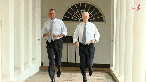 Political gif. Barack Obama and Joe Biden jogging together down a hallway in the White House in their dress clothes.