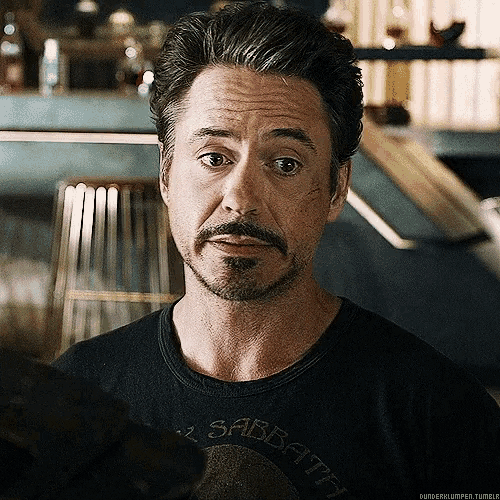 Celebrity gif. Robert Downey Jr looks off to the side and cringes.