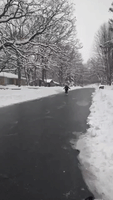 Girl Skates Down Street as Twin Cities See Icy Conditions