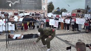 Protesters in Kyiv Reenact Deaths of Olenivka POWs Killed in Rocket Attack