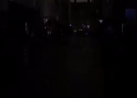 Singers Harmonize in Darkness on Frith Street During SoHo Power Outage