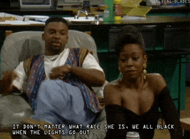 TV gif. Carl Payne as Cole in Martin leans back in an armchair and crosses his arms and legs in a smart aleck way, saying "It don't matter what race she is, we all black when the lights go out."