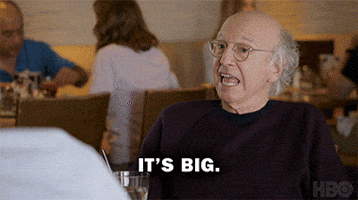TV gif. Comedians Larry David, Jeff Garlin, and JB Smoove in Curb Your Enthusiasm sit around a restaurant table. David says, "It's really big." while Garlin asks "how big?" and JB exclaims "wow!" Text, "it's really big", "how big?", "wow."