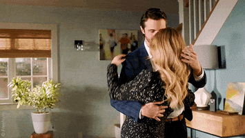 TV gif. A man dips a woman and kisses her in a domestic interior, from the show Pretty Little Liars.