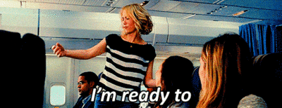 Movie gif. Kristen Wiig as Annie in Bridesmaids stands on an airplane as she sways and dips sluggishly. Text, "I'm ready to paaaarty!" with heavy emphasis on the party.
