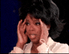 Celebrity gif. Oprah Winfrey holds her hands to the sides of her head, and her mouth is open as she seems stunned, her eyes looking about in disbelief. 