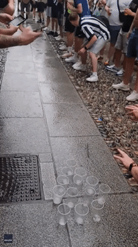 Newcastle Fans Slide on Wet Pavement 