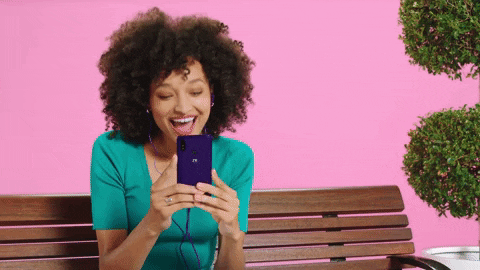 A woman is talking to someone on FaceTime and sending a flying kiss.