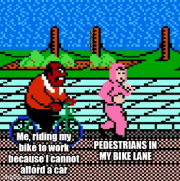 Meme gif. Animation of very old video game shows a man riding a bike behind a woman running. The man is labeled "Me, riding my bike to work because I cannot afford a car," and the woman is labeled, "Pedestrians in my bike lane."