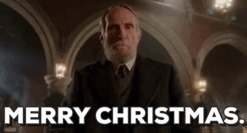 Movie gif. Roberts Blossom as Marley in Home Alone. He looks down at us and thinks for a moment before softening into a smile and saying, "Merry Christmas."