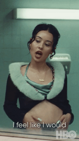 TV gif. Alexa Demie as Maddy on Euphoria, looks at herself in the mirror of a public bathroom. Her stomach is visible in her outfit and she puts her hand on it as she looks at it in the mirror, saying, "I feel like I would look so sexy pregnant."