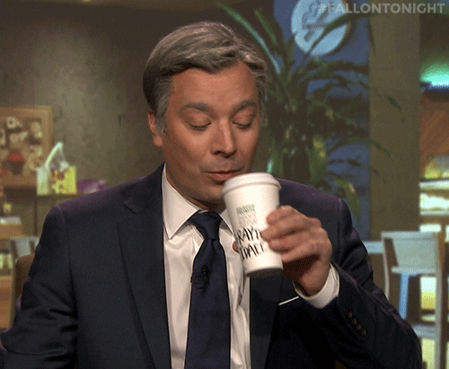 Tonight Show gif. A gray-haired Jimmy sips a cup of coffee, then immediately spits it out.