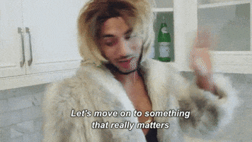 Celebrity gif. Joanne the Scammer disdainfully walks away from a kitchen cabinet, then brushes hair from their eyes. Text, Let's move on to something that really matters.