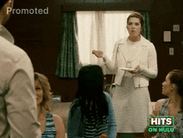 Sponsored GIF. Annie Murphy stands in the middle of a room with people gathered at a celebration as she eats a slice of cake. She pauses in horror, looks up and exclaims “Omg ew, David!” in utter disgust.