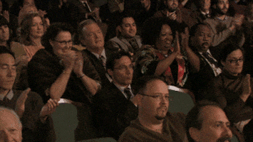 sales funnel - The Office gif. Phyllis, Bob Vance, and other people in the audience get up from their seats to give a standing ovation, while Leslie David Baker as Stanley looks at us begrudgingly and rises.