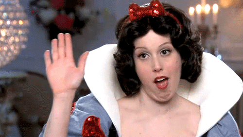 SNL gif. Comedian Vanessa Bayer dressed as Snow White gets a volley of high-fives from dwarf-sized hands. 