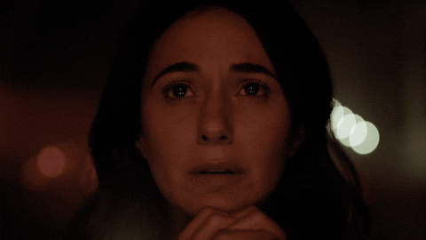 TV gif. Emmanuelle Chriqui as Dr. Lila Kyle on The Passage closes her eyes and holds her hands under her chin to pray.