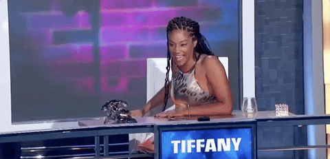 Celebrity gif. Tiffany Haddish laughs and leans back, clapping.