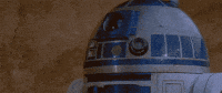 Star Wars gif. Closeup of R2D2's face and then we zoom out to see him fall forward and face plant on the ground. Text, "Dead."