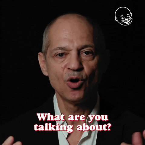 Celebrity gif. Caveh Zahedi taps his fingers to the sides of his head and asks, incredulously, "What are you talking about?" which appears as text.