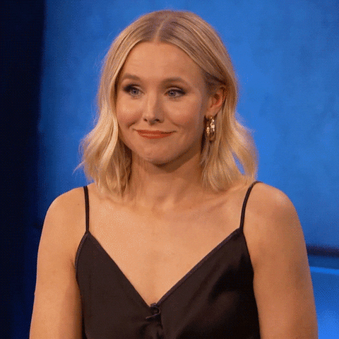 Celebrity gif. Actress Kristen Bell aggressively shrugs her shoulders with a feigned expression of ignorance. 