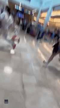 Chaotic Scenes at Cancun International Airport After Falling Signs Spark Panic