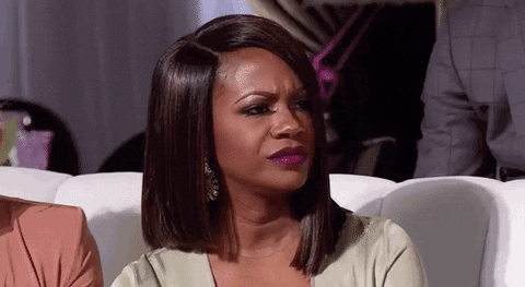Reality TV gif. Kandi Burruss on The Real Housewives of Atlanta. She looks around in confusion before scrunching her eyebrows and saying, "Okay..."