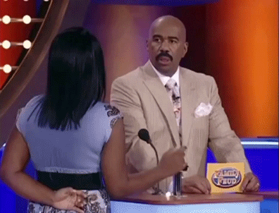 Reality TV gif. Steve Harvey on Family Feud looks at a girl who is giggling. He has a stunned expression on his face. He blinks and shakes his head, furrowing his brows at her to figure out what she had just said to him. 