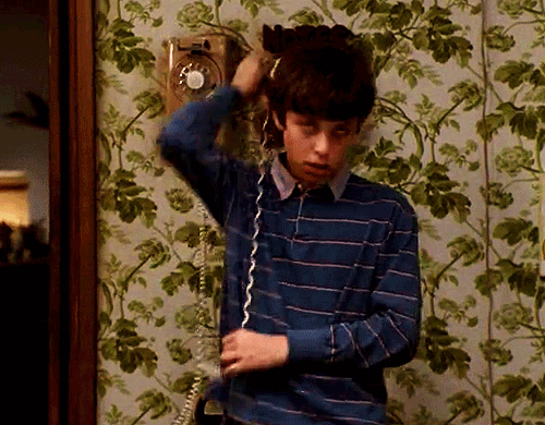 TV gif. John Francis Daley as Sam in Freaks and Geeks. There's a landline phone on the wall and he wraps the phone and the cord around his neck, pretending to choke himself.