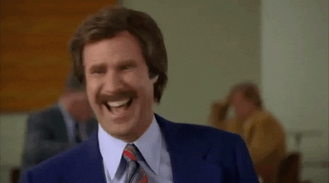 Movie gif. Will Ferrell as Ron Burgundy in Anchorman laughs very hard and looks around the table as he says, “We are laughing.”