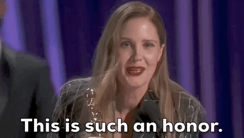 Oscars 2024 gif. Justine Triet accepts the award for best original screenplay for Anatomy of a Fall. She bends down to meet the microphone and says while looking at the audience, "This is such an honor."