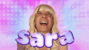TV gif. Wearing a platinum blonde wig and braces, Jimmy Fallon smiles like a teen girl, against a pink and blow glowing background and behind bubbly text that reads "Sara."