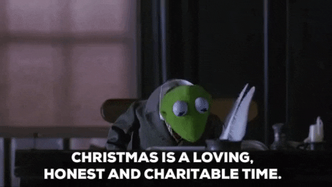 Cartoon gif. Kermit from The Muppet Christmas Carol. He sits at a desk in a suit and looks up while giving us a gentle smile and says, "Christmas is a loving, honest, and charitable time."