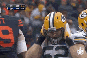 Sports gif. Clay Matthews on the Green Bay Packers is doing an end zone celebration. He dances sexily and touches his body from head to hip, feeling himself.