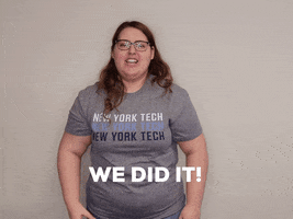 Video gif. Woman pumps her fists and jumps, pulling her elbows to her knees as she declares, "We did it!"