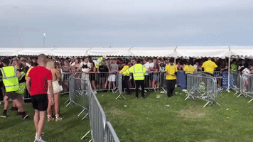 Crowds Rush Barriers Following Long Delays at London Festival