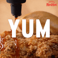 Sponsored gif. Frank’s RedHot sauce is slowly drizzled across crispy fried chicken. Text reads, “Yum.”