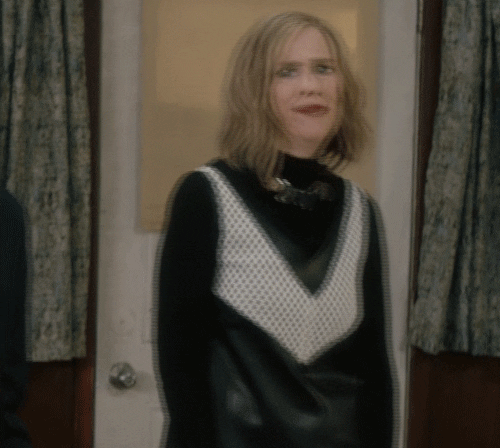 Schitt's Creek gif. Catherine O'Hara as Moira raises her fist as she turns away from the camera, saying with gusto, "Courage!"