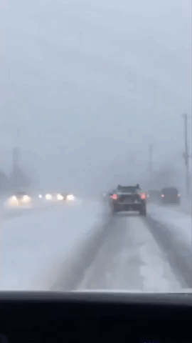 Cars Brave Snow-Slicked Roads in Western New York