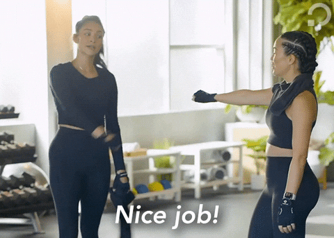 Celebrity gif. Shay Mitchell fist bumps her workout buddy saying "nice job!"