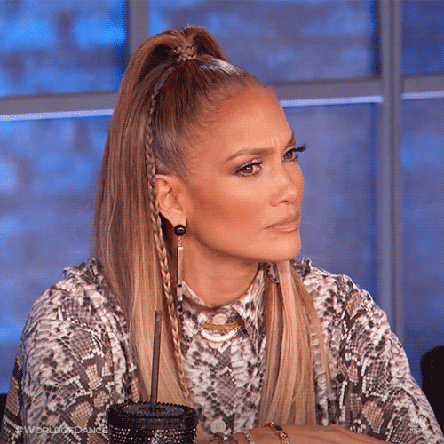 Reality TV gif. Jennifer Lopez on World of Dance turns her head with a confused look on her face. She then opens her mouth in amazement. 