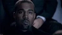 Celebrity gif. Kanye West is watching something and he has a straight expression on his face but his eyes slowly blink as he mouths, 