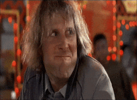 Movie gif. Jeff Daniels as Harry in Dumb and Dumber chews food and looks eagerly at Jim Carrey as Lloyd, who smiles with a mouthful of food; Harry grins and nods rapidly which makes Lloyd even more excited.