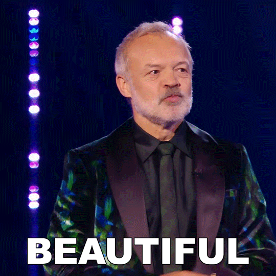 TV gif. Graham Norton on Queen of the Universe looks around, shaking his head in disbelief as he looks out at the judges and earnestly says, “Beautiful.”